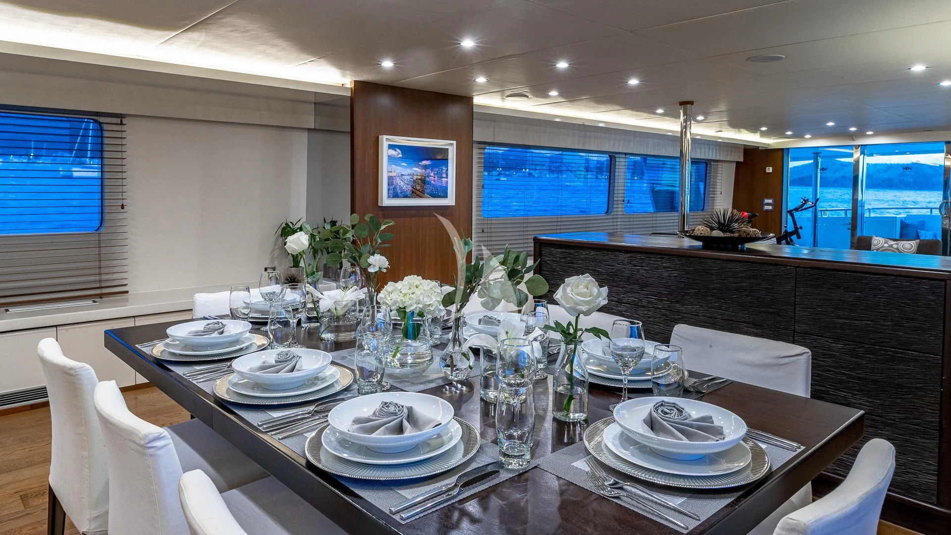 a table set with plates and flowers aboard KARTAL YUVASI Yacht for Charter
