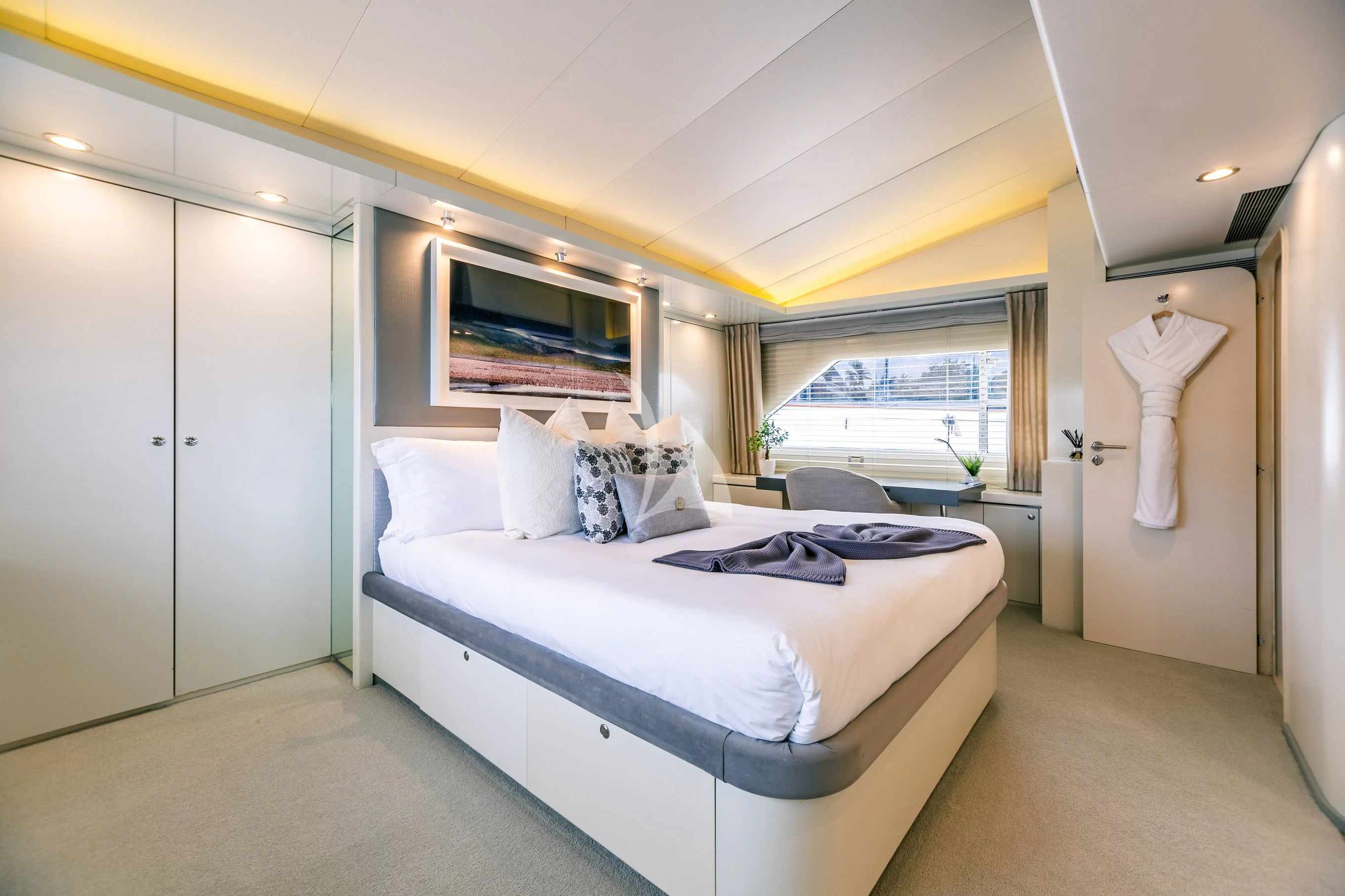 a bedroom with a bed and a window aboard KARTAL YUVASI Yacht for Charter