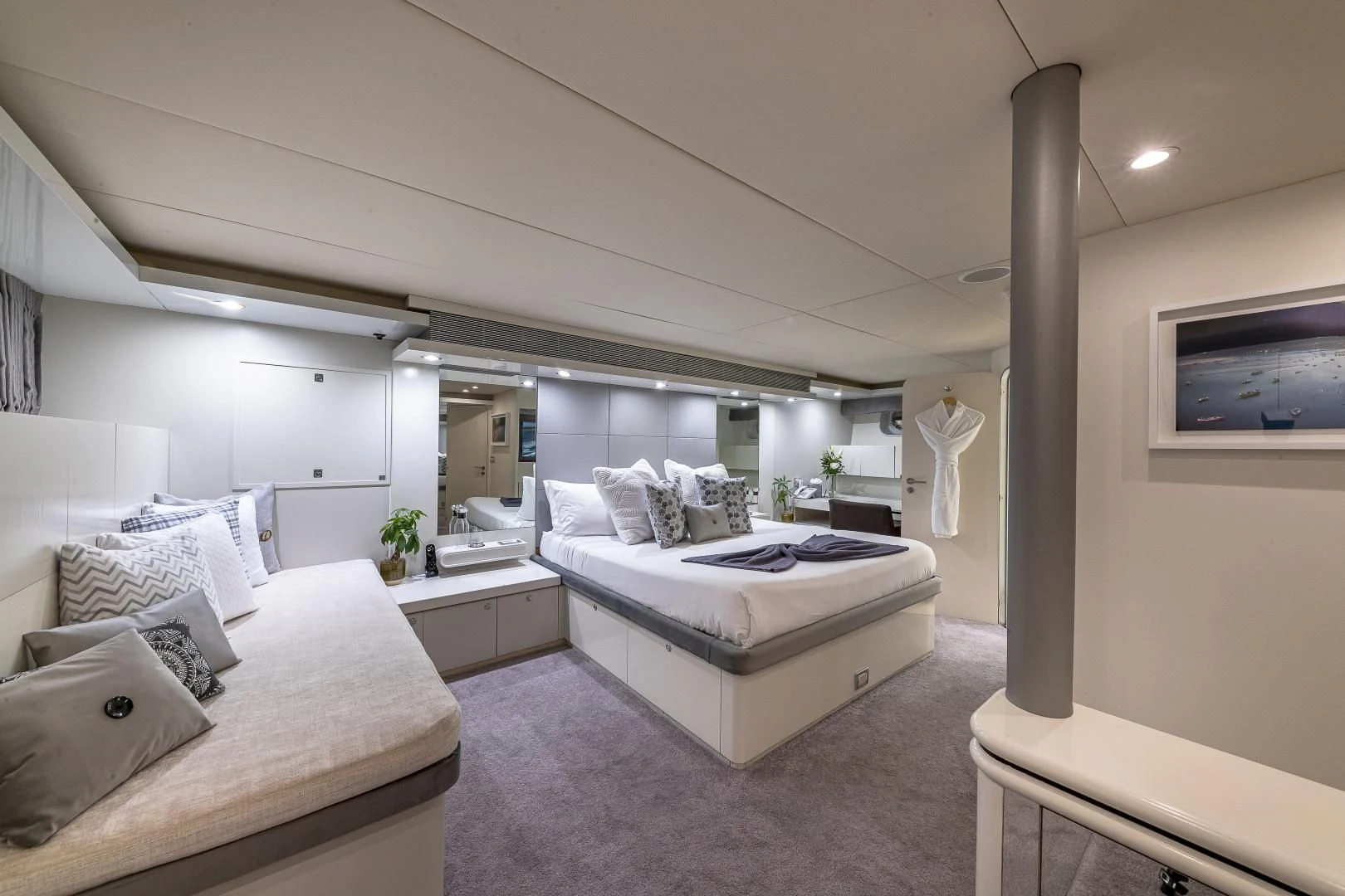 a bedroom with a bed and a mirror aboard KARTAL YUVASI Yacht for Charter