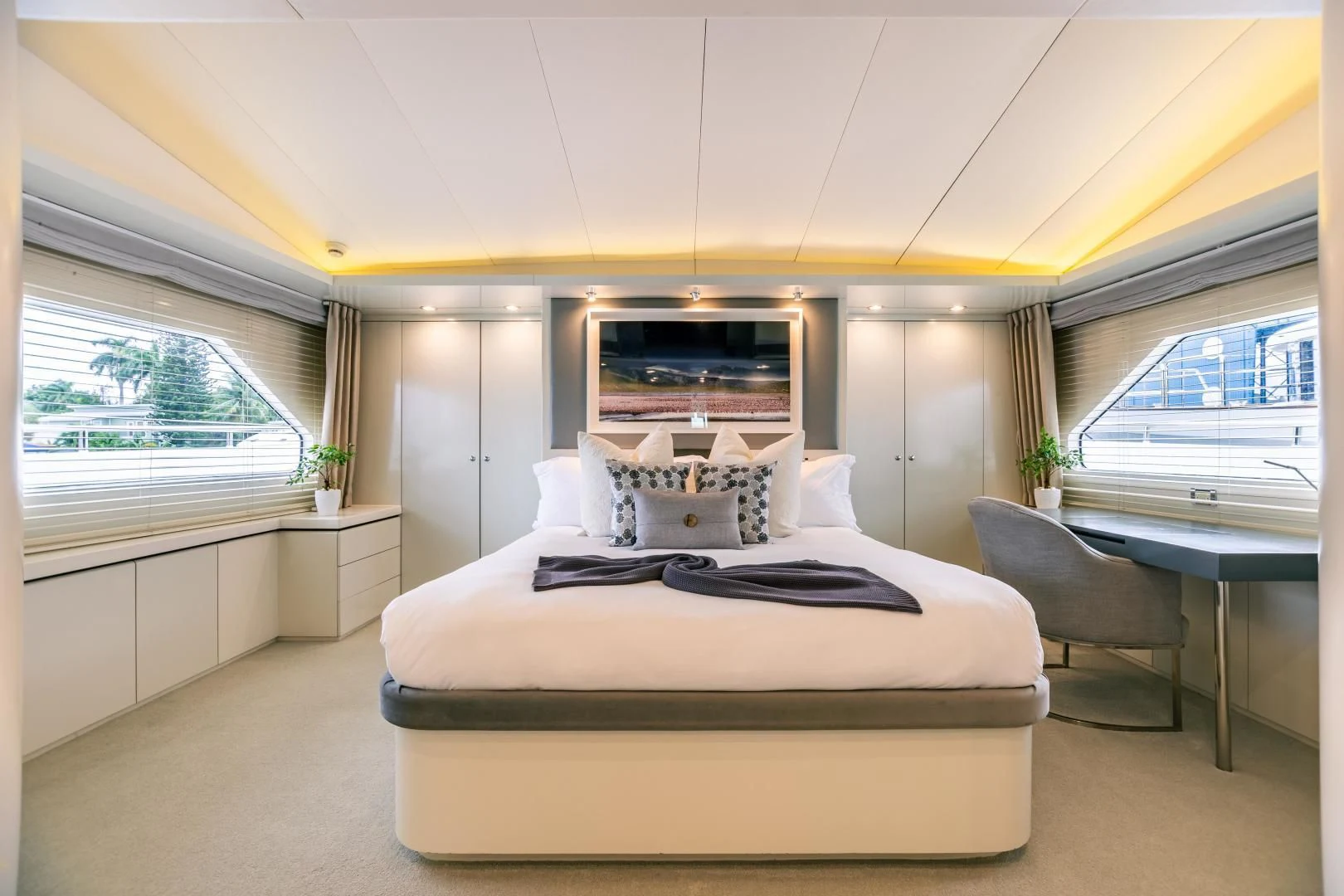 a bedroom with a bed and a desk aboard KARTAL YUVASI Yacht for Charter