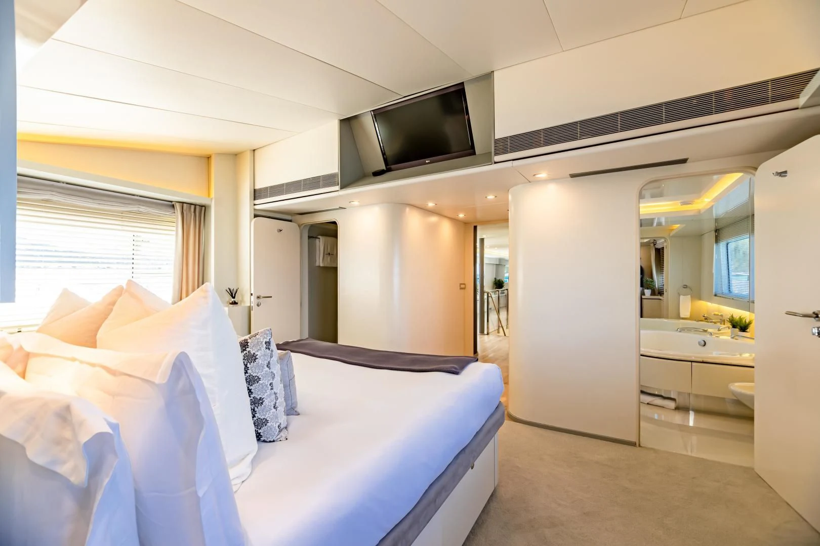a room with a bed and a television aboard KARTAL YUVASI Yacht for Charter