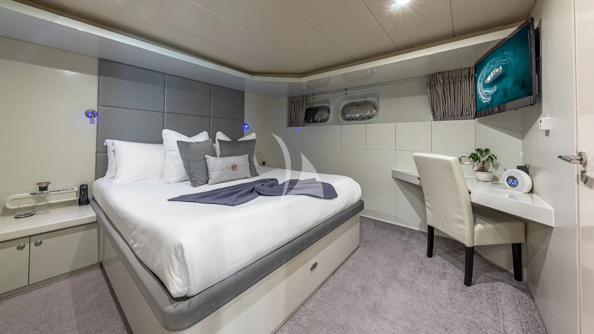 a bed and a chair in a room aboard KARTAL YUVASI Yacht for Charter