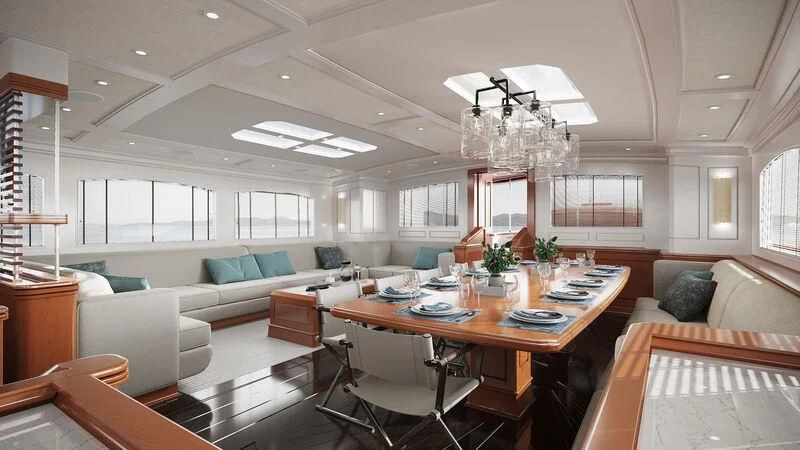 a large living room with a large table and couches aboard RAINBOW II Yacht for Sale