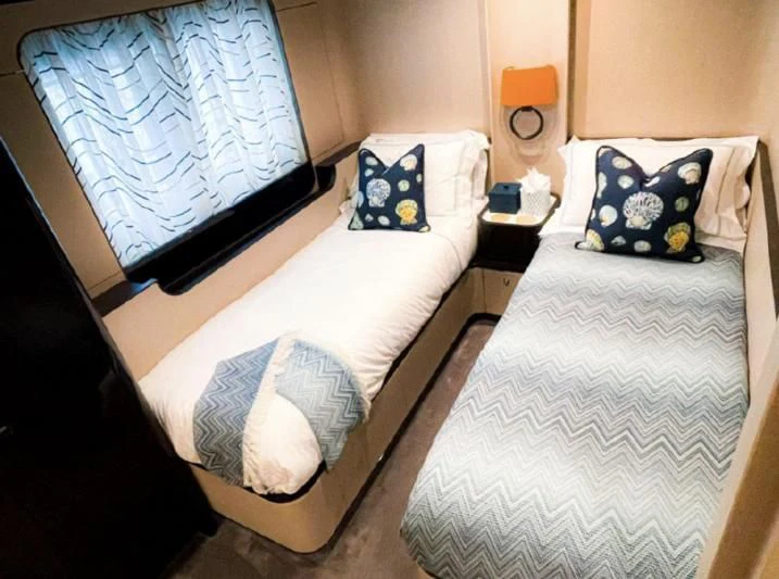a couple of beds in a hotel room aboard PENJA Yacht for Sale