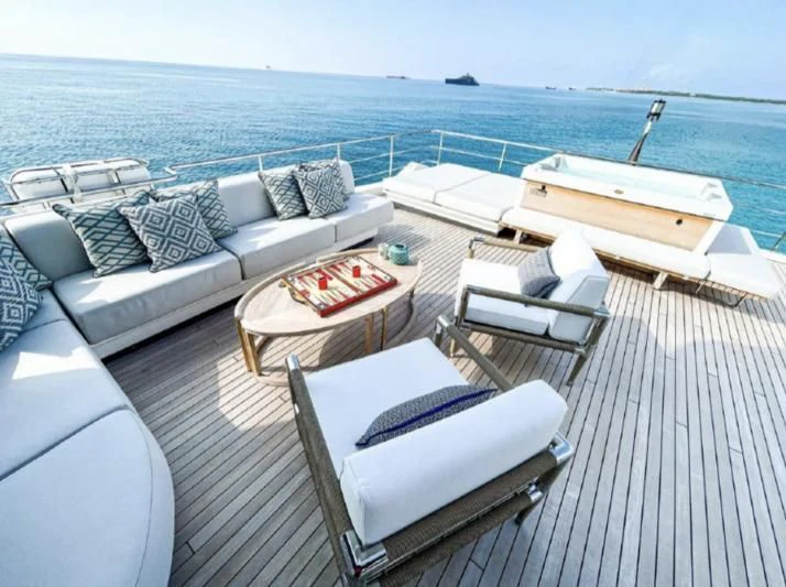 a deck with a couch and a pool on it aboard PENJA Yacht for Sale