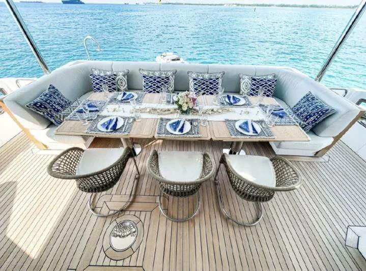 a table with a cloth and chairs on it aboard PENJA Yacht for Sale
