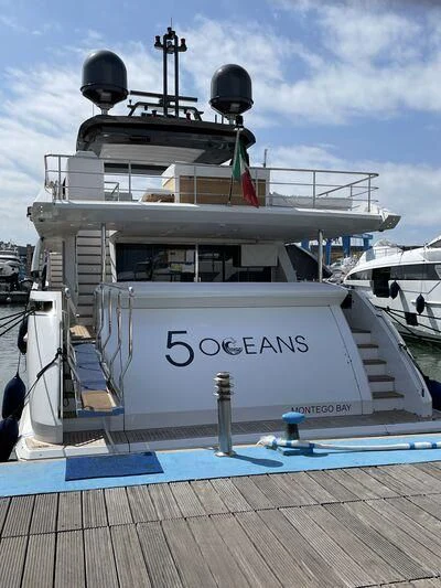 a large white boat with a sign on it aboard PENJA Yacht for Sale
