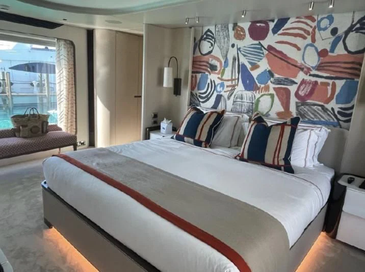 a bed with a blue and white bed spread aboard PENJA Yacht for Sale