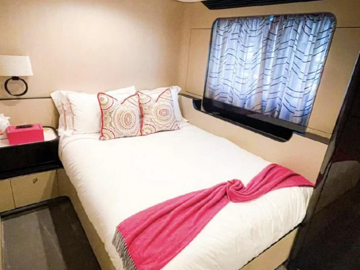a bed with a pink and white blanket aboard PENJA Yacht for Sale