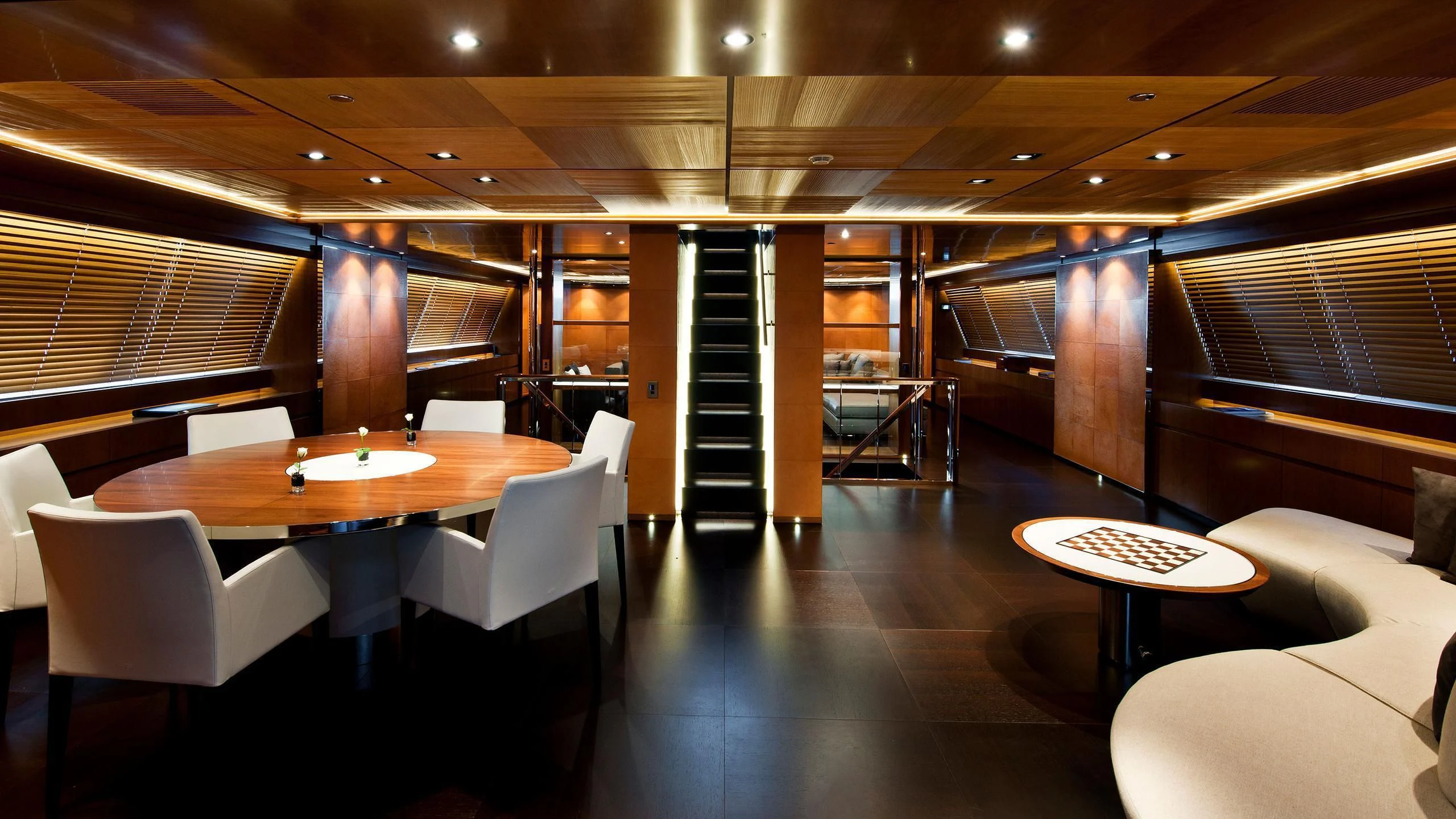 a room with a table and chairs aboard MELEK Yacht for Sale
