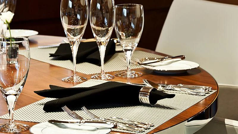a table with wine glasses and silverware on it aboard MELEK Yacht for Sale