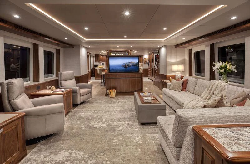 a living room with a tv and furniture aboard NEW JOURNEY Yacht for Sale