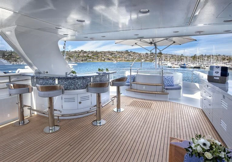 a room with a table chairs and a large body of water aboard NEW JOURNEY Yacht for Sale