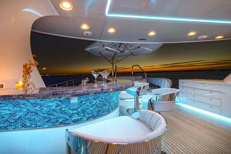 a room with a table and chairs aboard NEW JOURNEY Yacht for Sale