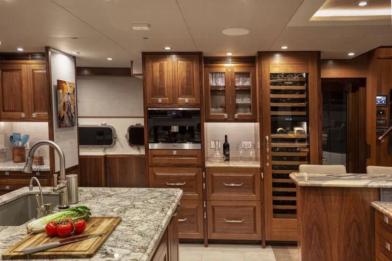 a kitchen with wooden cabinets aboard NEW JOURNEY Yacht for Sale