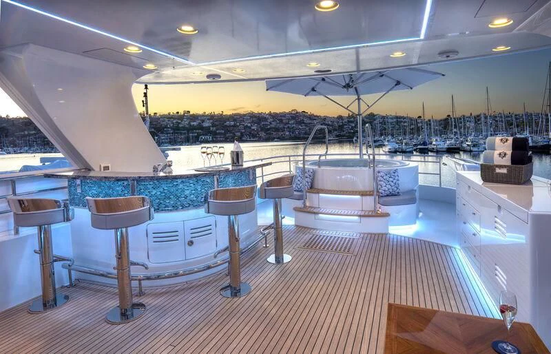 a pool with tables and chairs aboard NEW JOURNEY Yacht for Sale