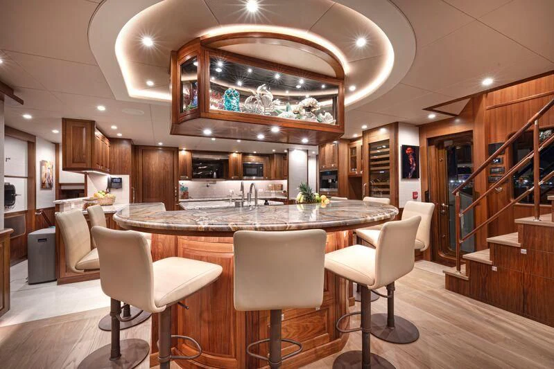 a large room with a table and chairs aboard NEW JOURNEY Yacht for Sale