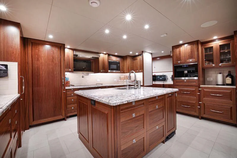 a kitchen with wooden cabinets aboard NEW JOURNEY Yacht for Sale