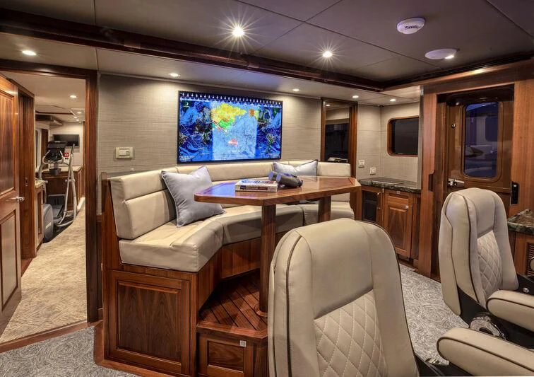 a living room with a table and chairs aboard NEW JOURNEY Yacht for Sale