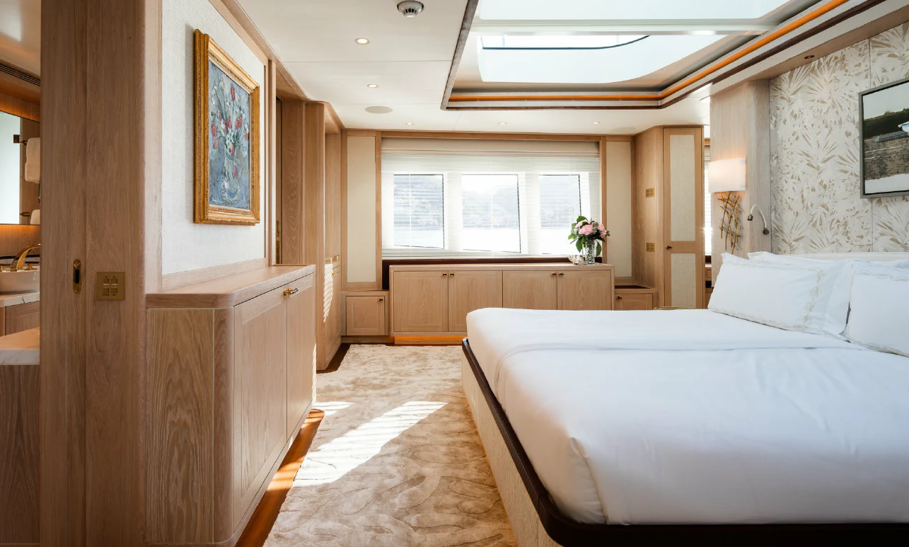 a bedroom with a bed and a desk aboard SEAFLOWER Yacht for Sale