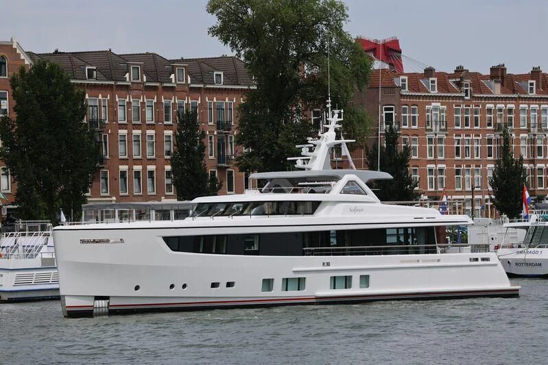 a large white boat in a harbor aboard SEAFLOWER Yacht for Sale