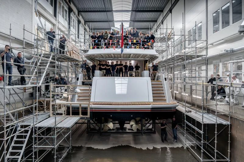 a group of people standing on a staircase with a large white box on top of it aboard SEAFLOWER Yacht for Sale
