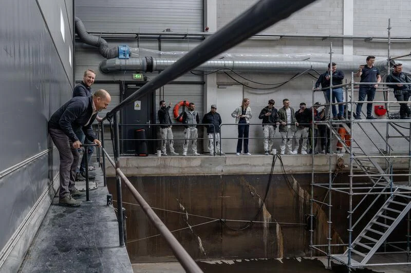 a group of people working on a pipe aboard SEAFLOWER Yacht for Sale