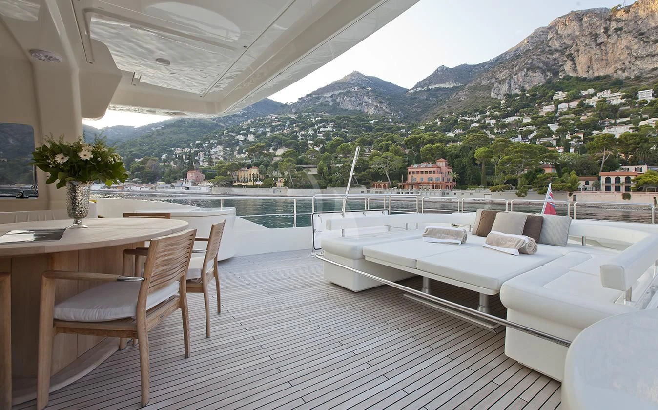 a room with a bed and a table and chairs aboard LA PAUSA Yacht for Sale
