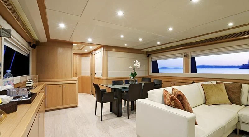 a living room with a couch and a table aboard LA PAUSA Yacht for Sale