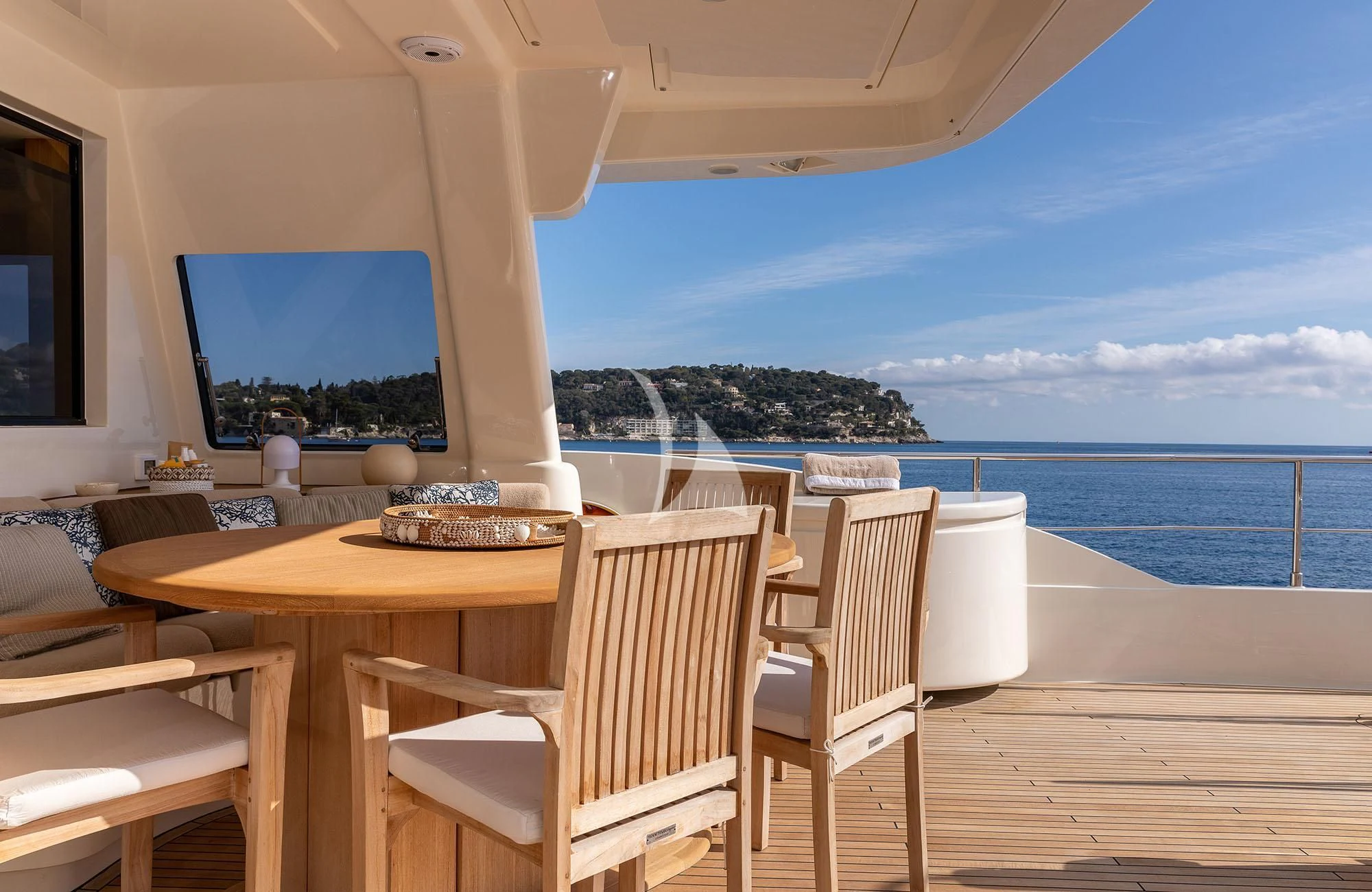 a room with a table and chairs on a deck overlooking the ocean aboard LA PAUSA Yacht for Sale