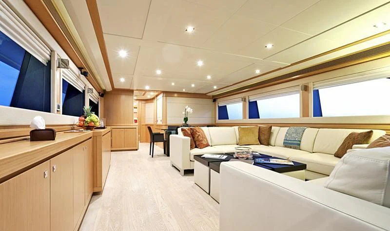 a living room with a couch and a table aboard LA PAUSA Yacht for Sale