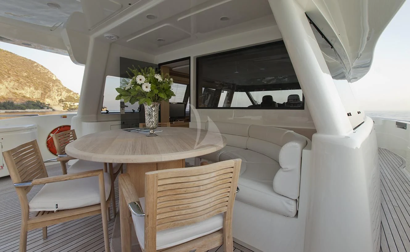 a table and chairs in a room aboard LA PAUSA Yacht for Sale