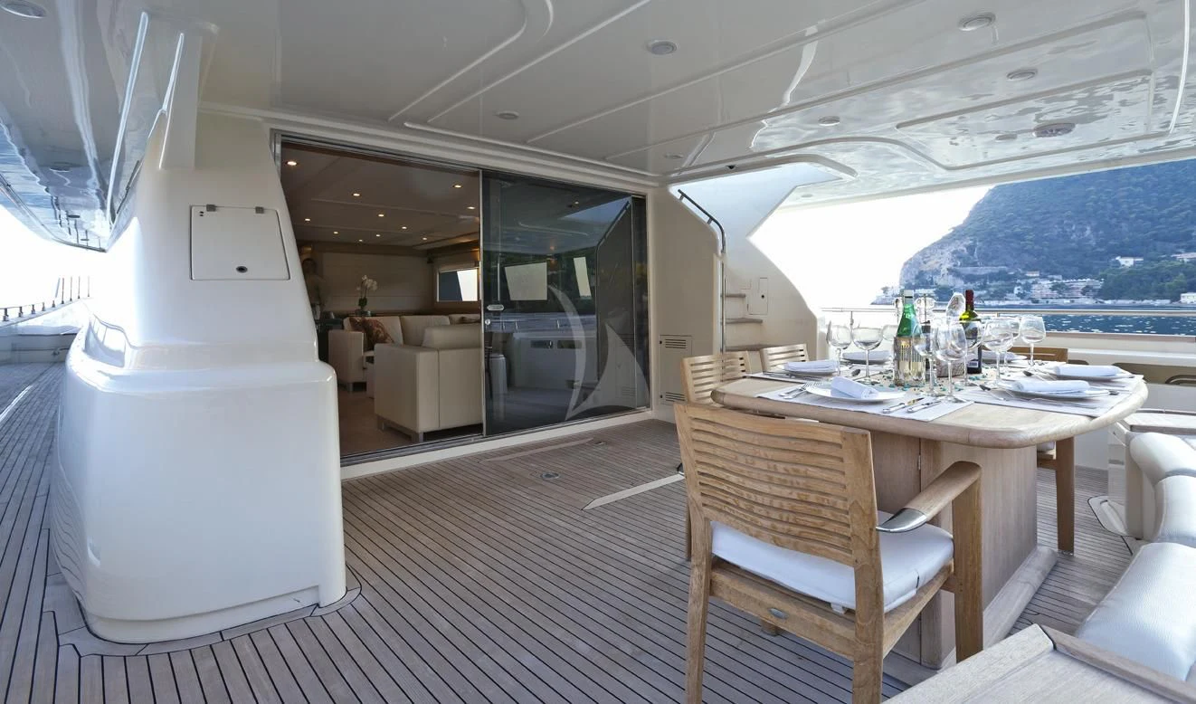 a boat with a table and chairs aboard LA PAUSA Yacht for Sale