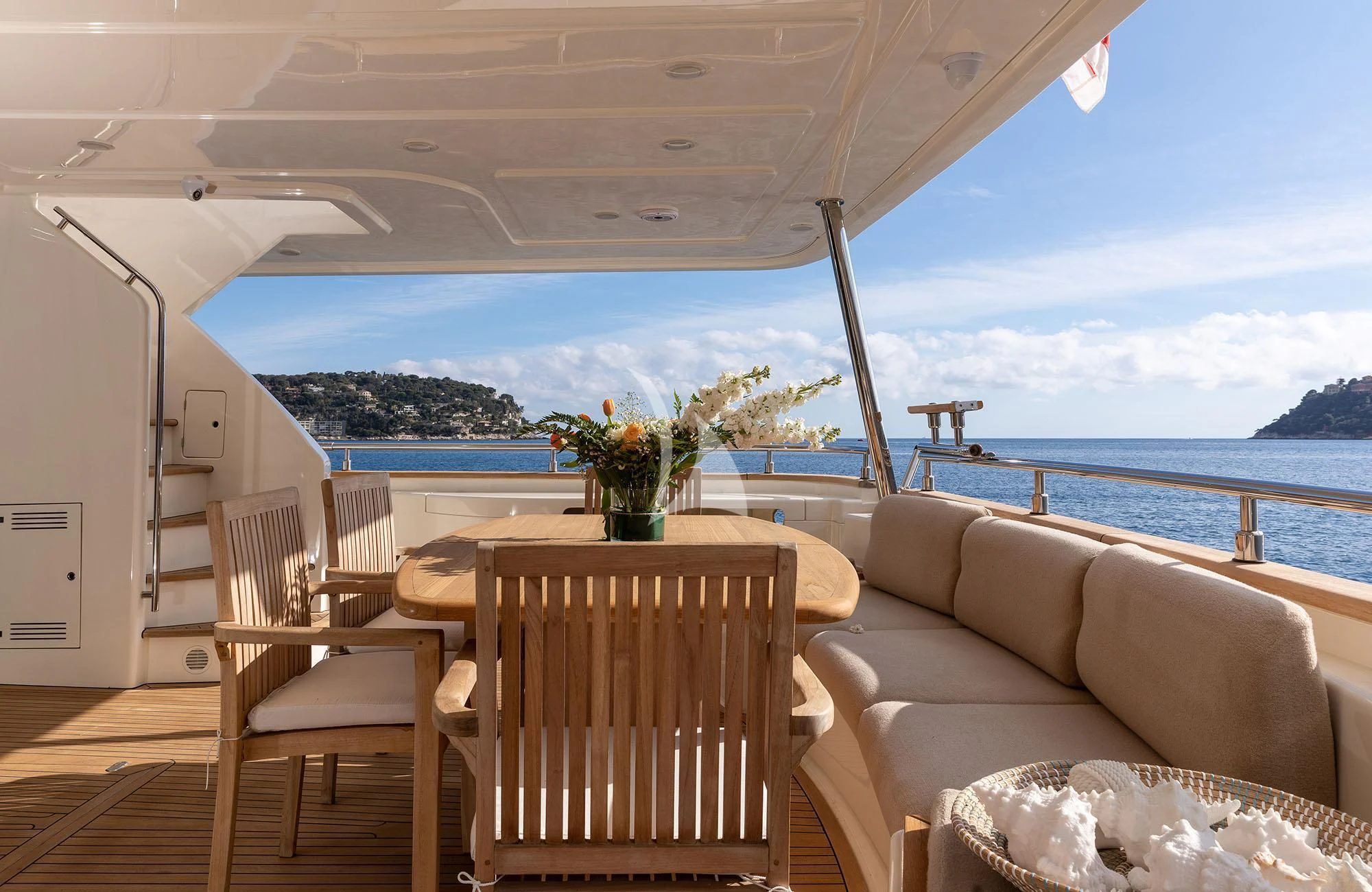 a patio with chairs and a table aboard LA PAUSA Yacht for Sale