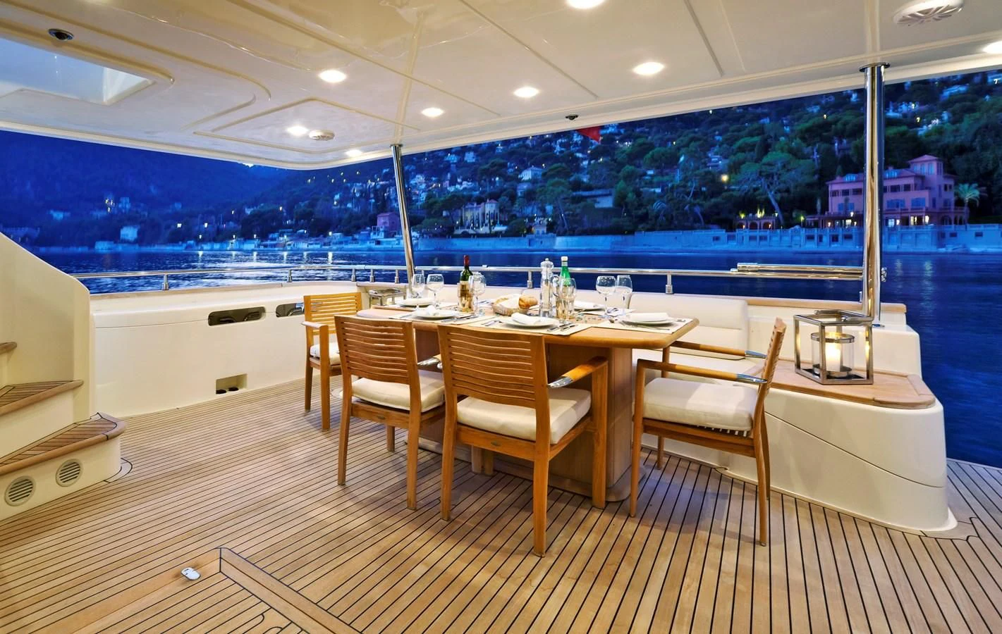 a table with chairs and a bar aboard LA PAUSA Yacht for Sale
