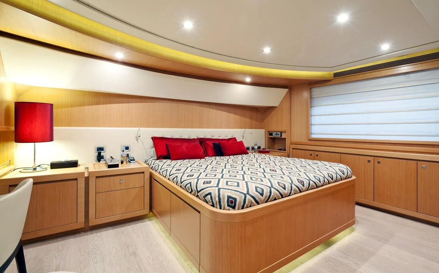 a bedroom with a bed and desk aboard LA PAUSA Yacht for Sale