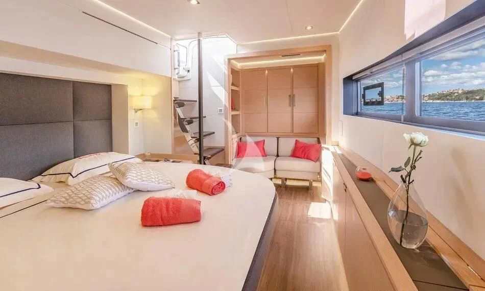 a bedroom with a bed and a table aboard CHILOE Yacht for Charter