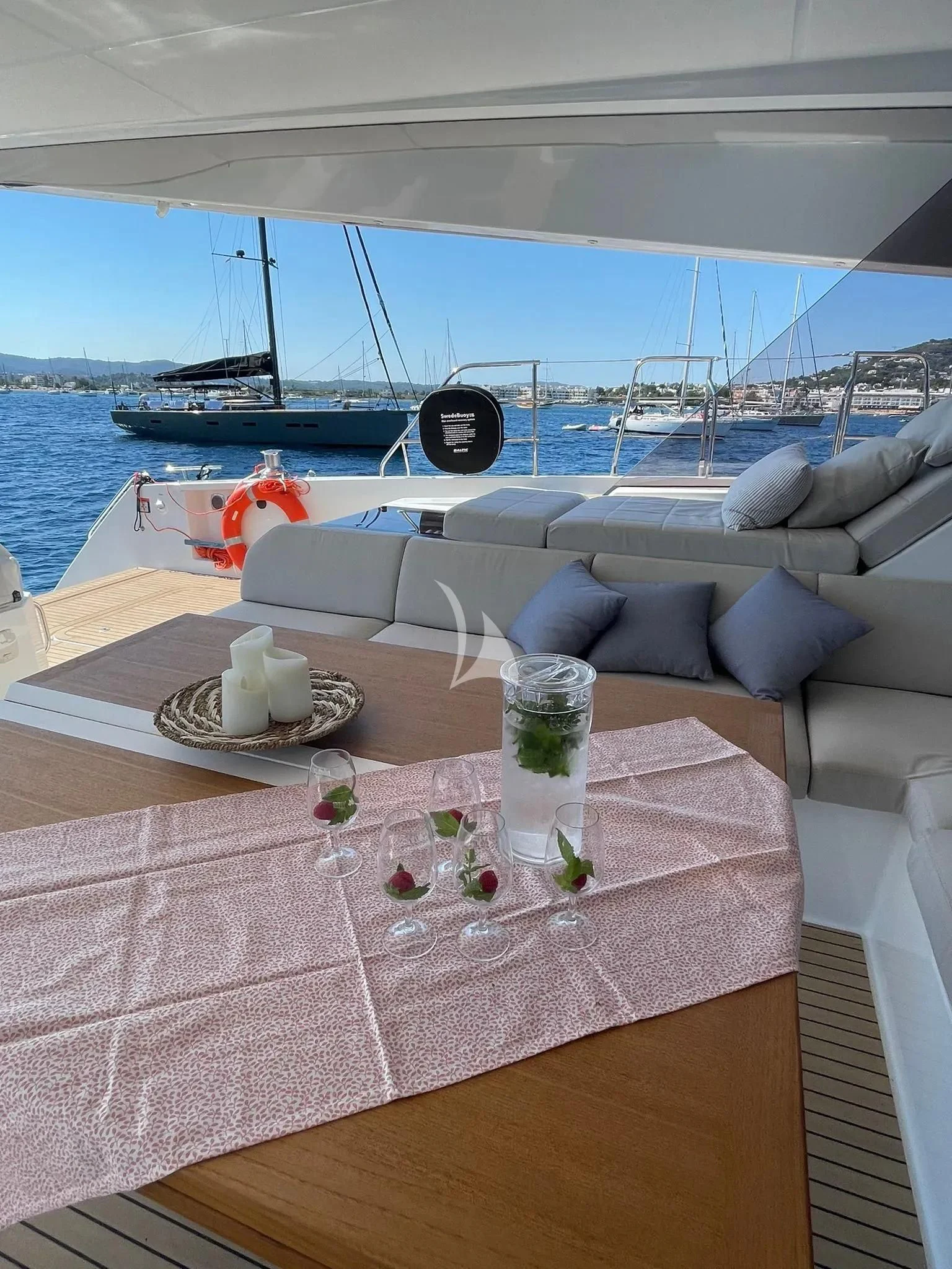 a table with glasses and a bottle on it aboard CHILOE Yacht for Charter