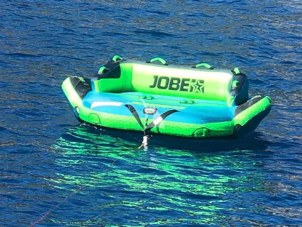 a small green boat in the water aboard G Yacht for Sale