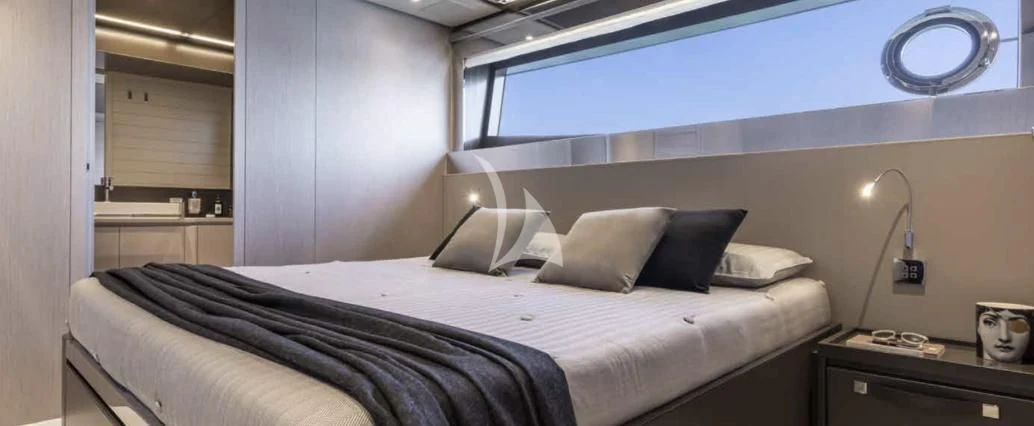 a bed with a white sheet and pillows on it aboard G Yacht for Sale