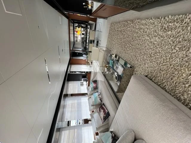 a long narrow hallway with a tile wall and a tile floor aboard G Yacht for Sale