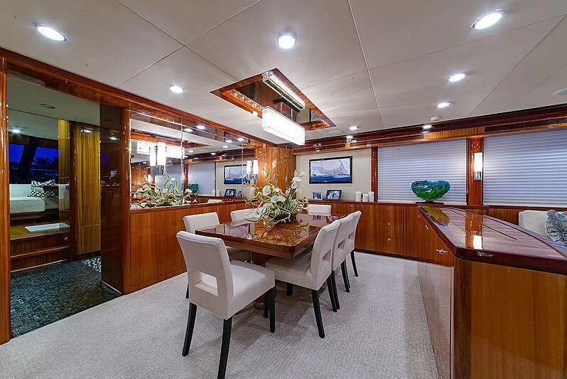 a room with a table and chairs aboard MI AMOR II Yacht for Sale