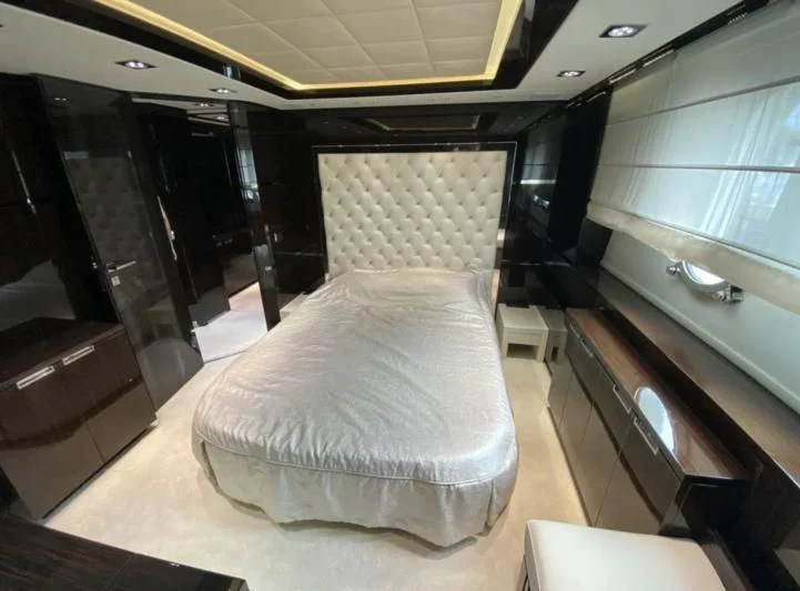 a room with a bed and a chair aboard WHITE PEARL Yacht for Sale