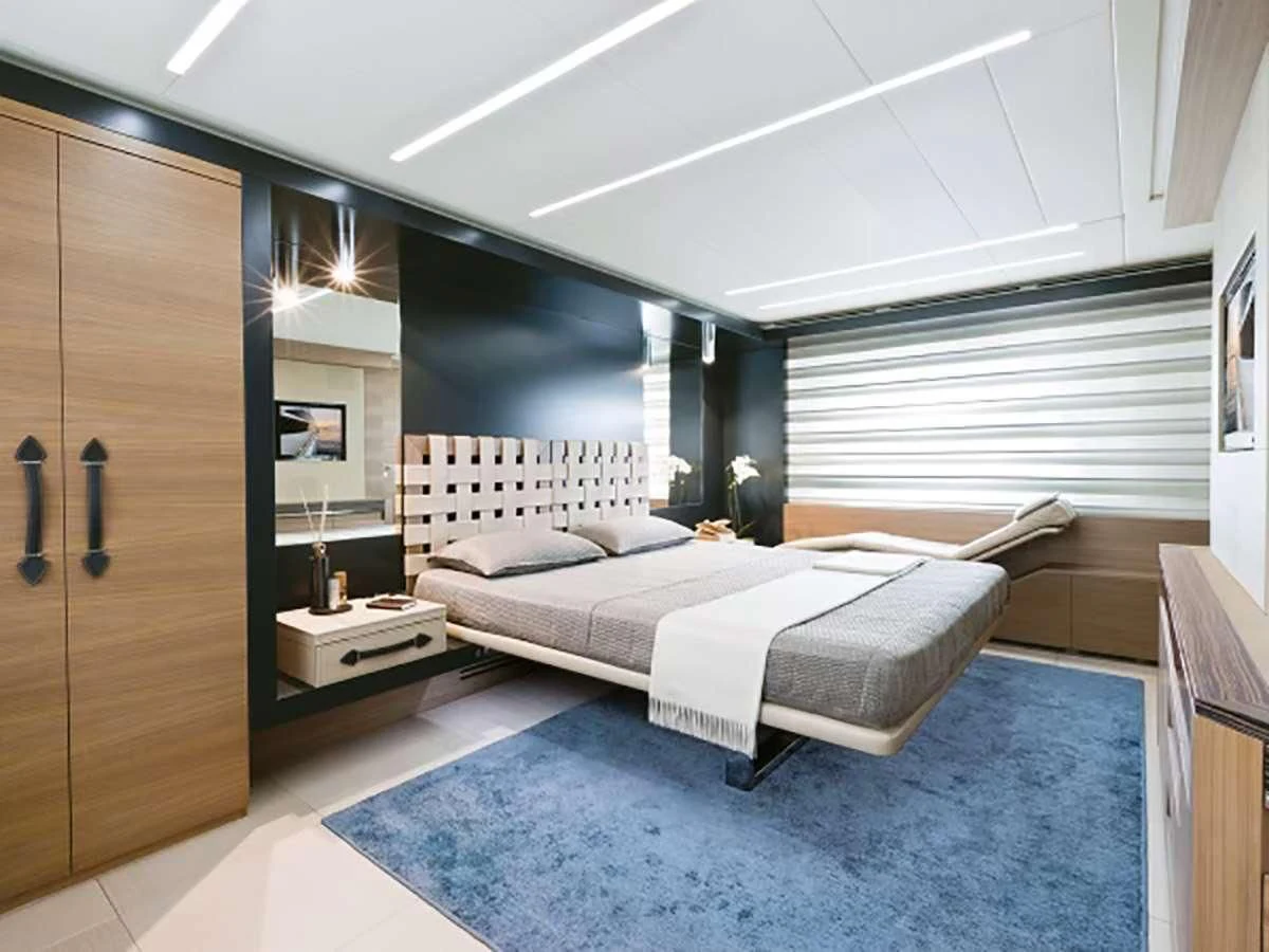 a bedroom with a bed and a desk aboard 92 PERSHING Yacht for Sale