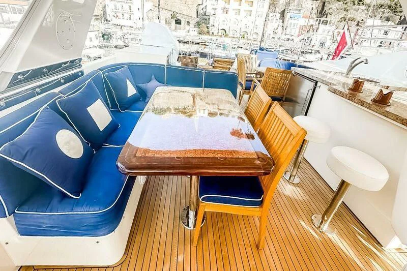 a table with chairs around it aboard JULE Yacht for Sale