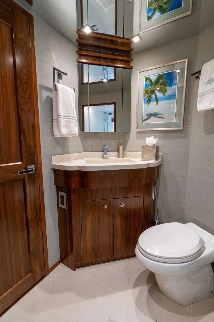 a bathroom with a toilet and a sink aboard OBSESSION Yacht for Sale