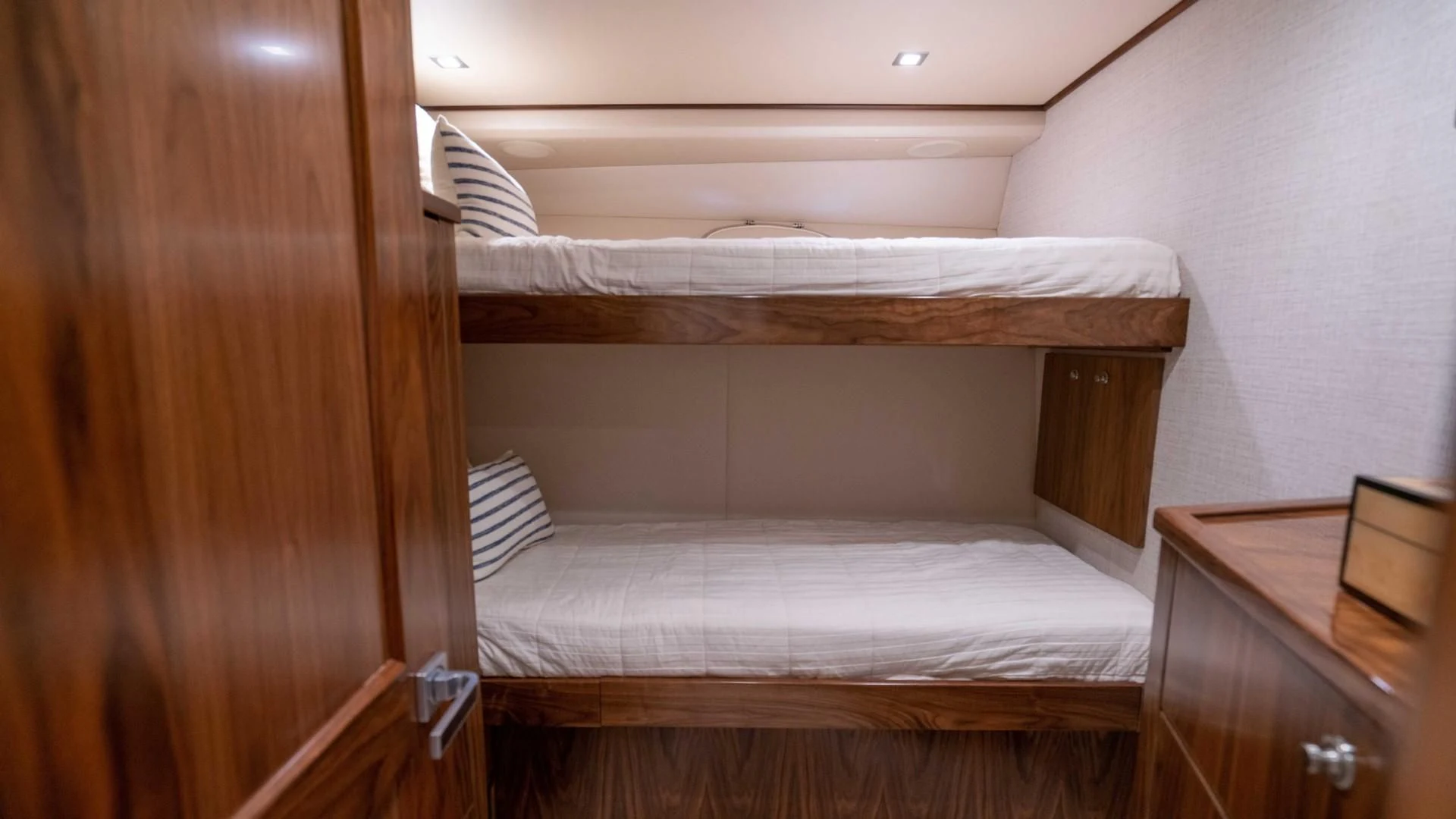 a bed with a wooden headboard aboard OBSESSION Yacht for Sale