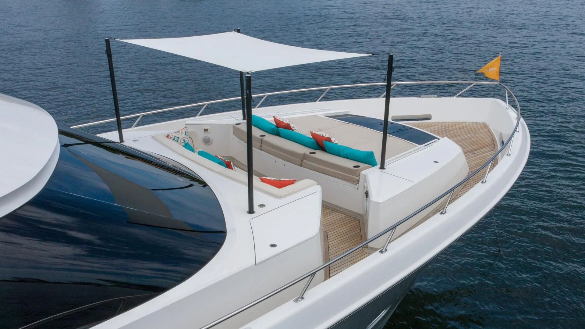 a boat with a flag on the front aboard OBSESSION Yacht for Sale