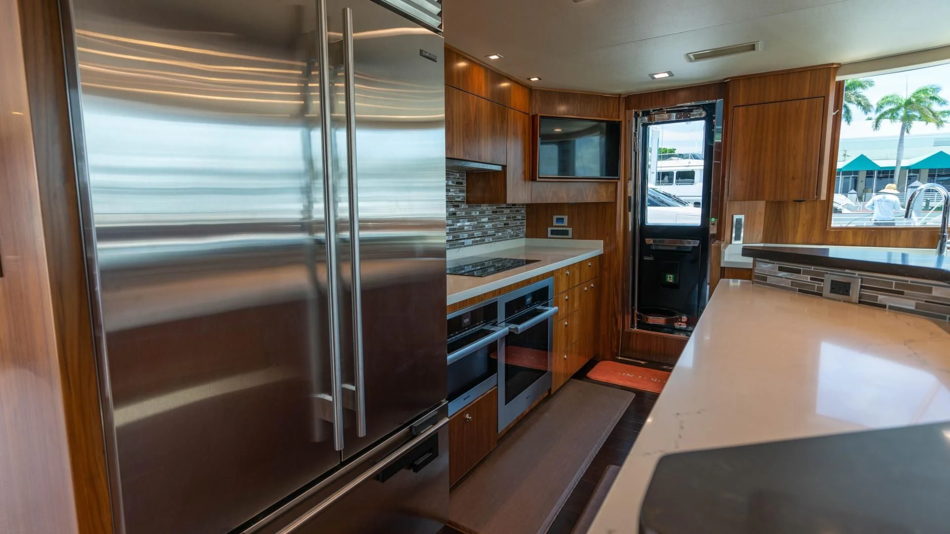 a kitchen with a glass door aboard OBSESSION Yacht for Sale
