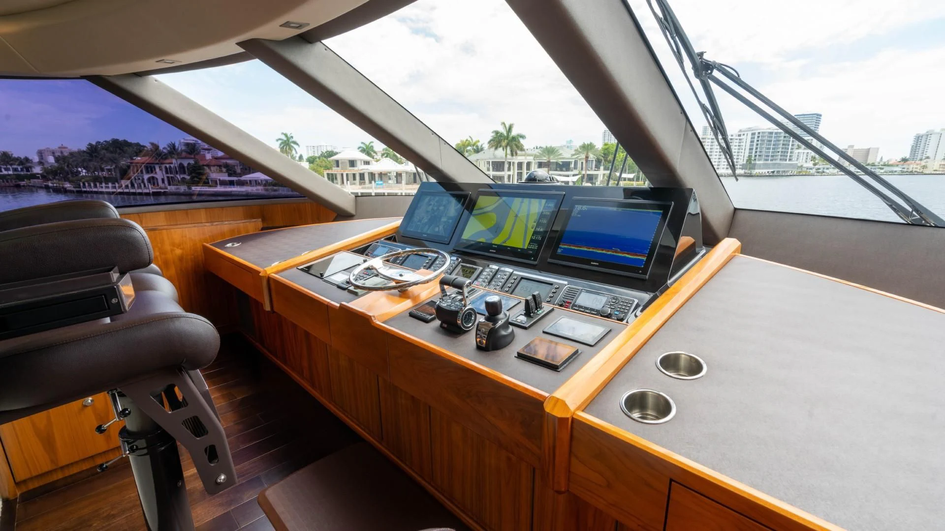 a room with a table and computer screens aboard OBSESSION Yacht for Sale